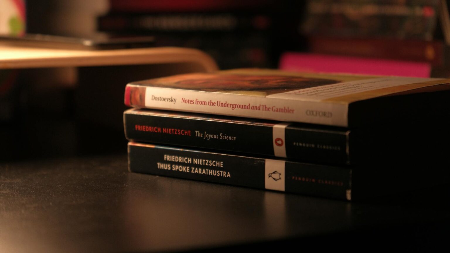 Stack of books on a wooden surface representing literary selections
