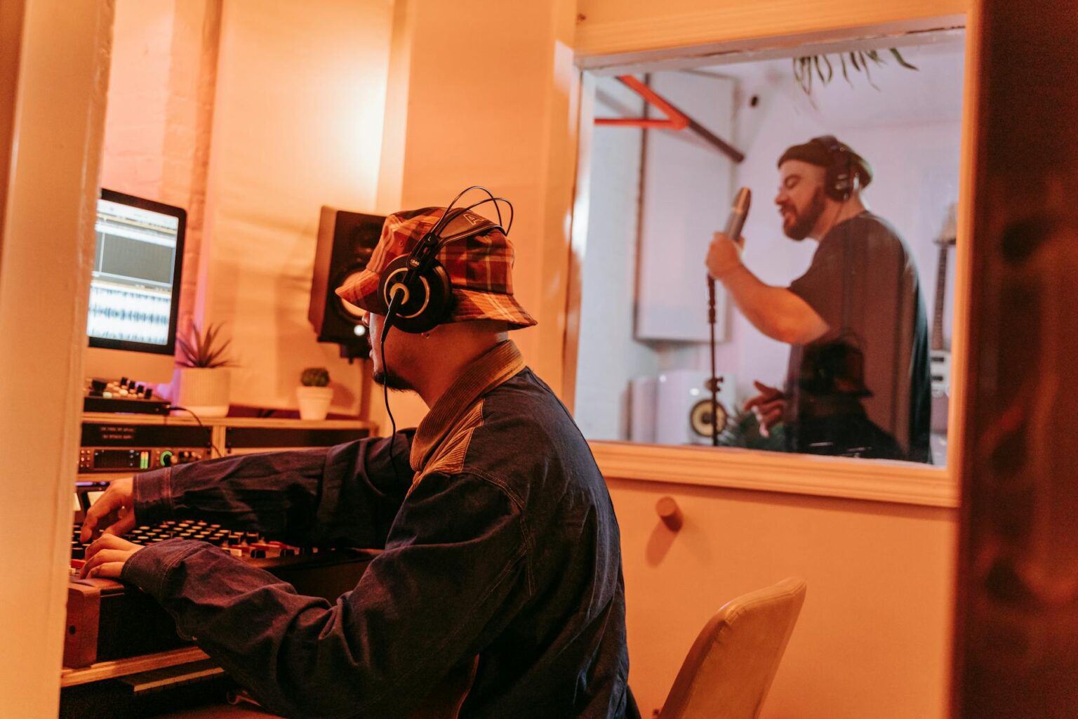 Professional music recording studio with mixing board and microphones
