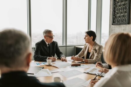 Why Tech Executives Are Hiring Professional Habit Formation Coaches Professional business meeting in modern office setting with executives discussing strategy