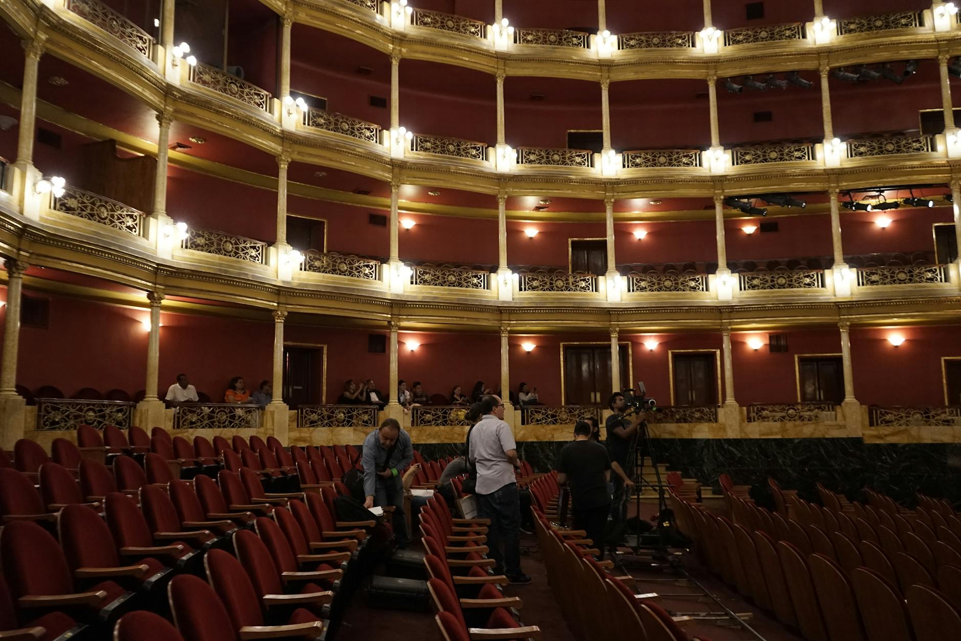Empty theater stage with dramatic lighting and red curtains