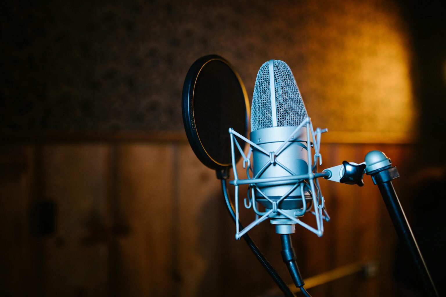 Why Major Studios Are Partnering With Podcast Networks Professional recording studio with microphone and audio equipment for podcast production