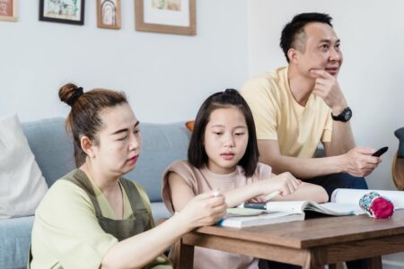 Celebrity Parents Are Choosing Homeschooling Over Private Schools Parent and child engaged in educational activity at home learning environment