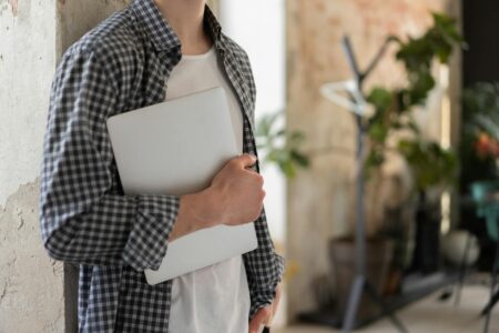 The Growing Trend of Adults Hiring Life Coaches in Their Twenties Young professional working on laptop in modern office space