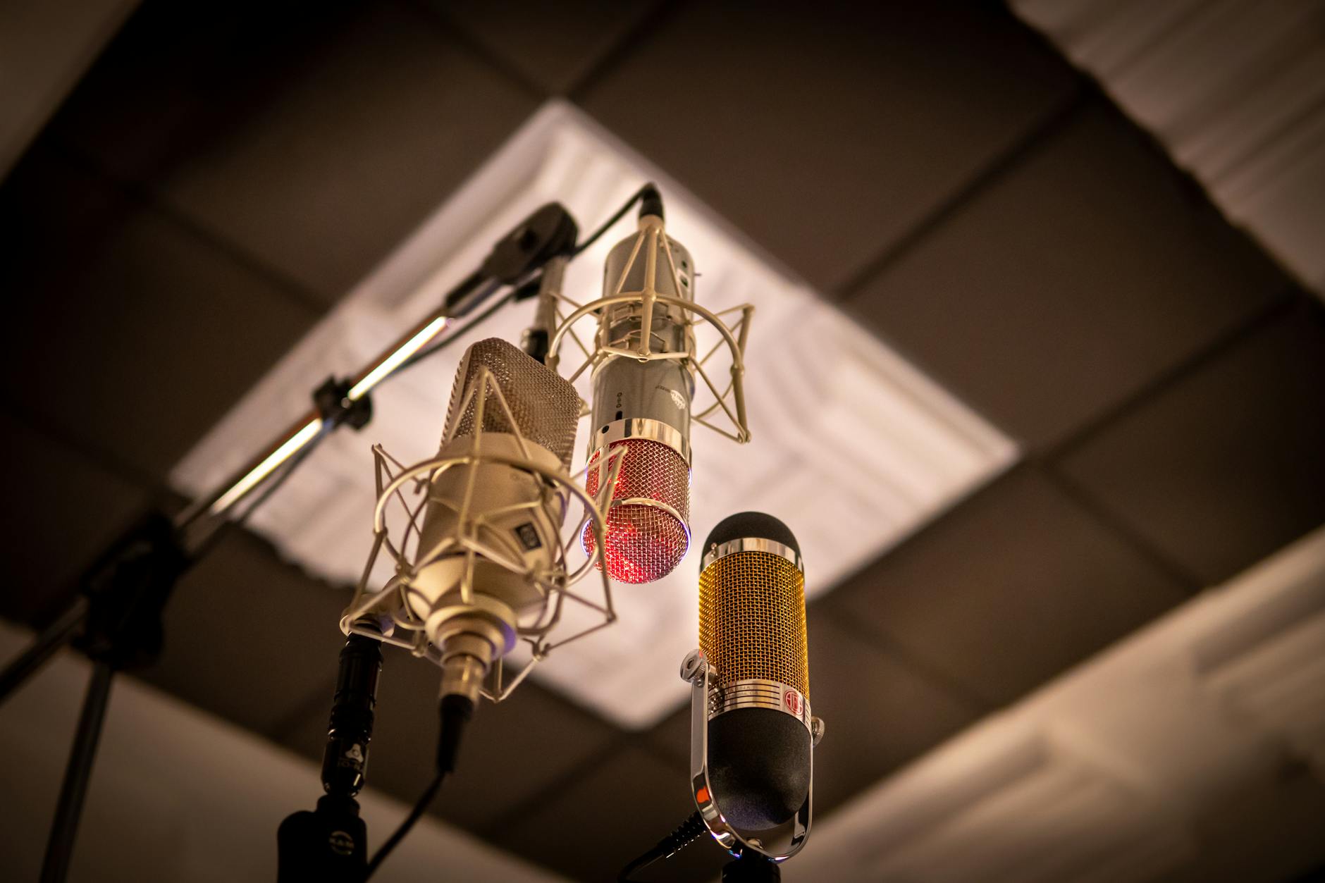 Professional recording microphone in studio setting with sound equipment in background