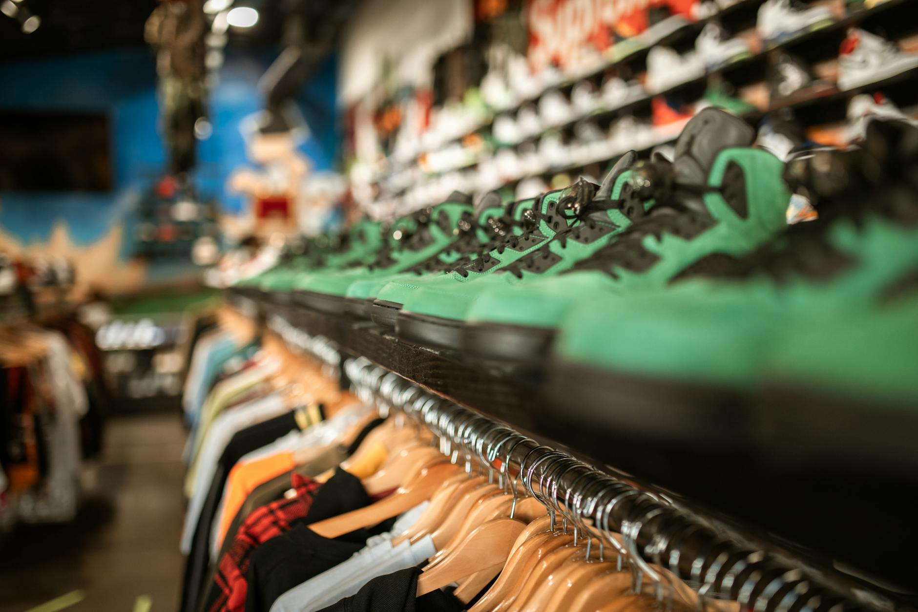 Collection of athletic sneakers displayed on shelves showing various styles and colors