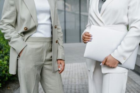 How Met Gala Looks Are Inspiring Everyday Workwear Trends Professional woman wearing a structured blazer with interesting sleeve details in modern office setting