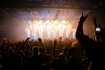 How Taylor Swift’s Eras Tour Changed Concert Merchandise Forever Large crowd at concert venue showing massive audience attendance