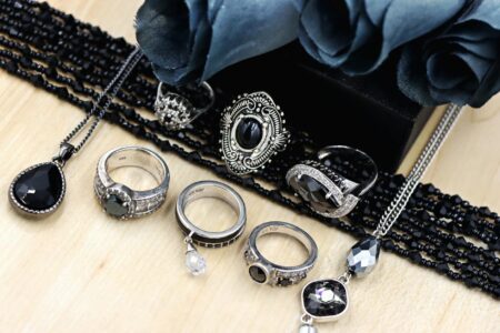 The Vintage Jewelry Trend Celebrities Are Making Mainstream Again Collection of elegant vintage jewelry pieces including necklaces and earrings displayed on dark fabric