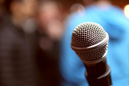 Inside Kevin Hart’s Comedy Academy Training the Next Generation Comedy club stage with microphone and spotlight setup