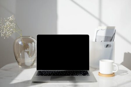 Why Millionaires Are Hiring Professional Decluttering Coaches for Digital Assets Professional workspace with laptop and organized desk setup