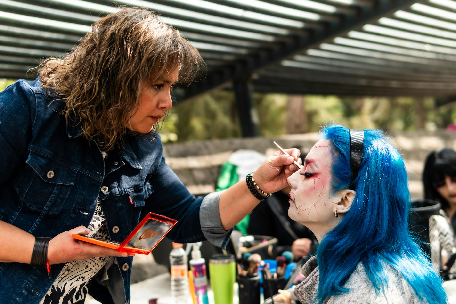 Professional makeup artist applying foundation to create glowing skin finish