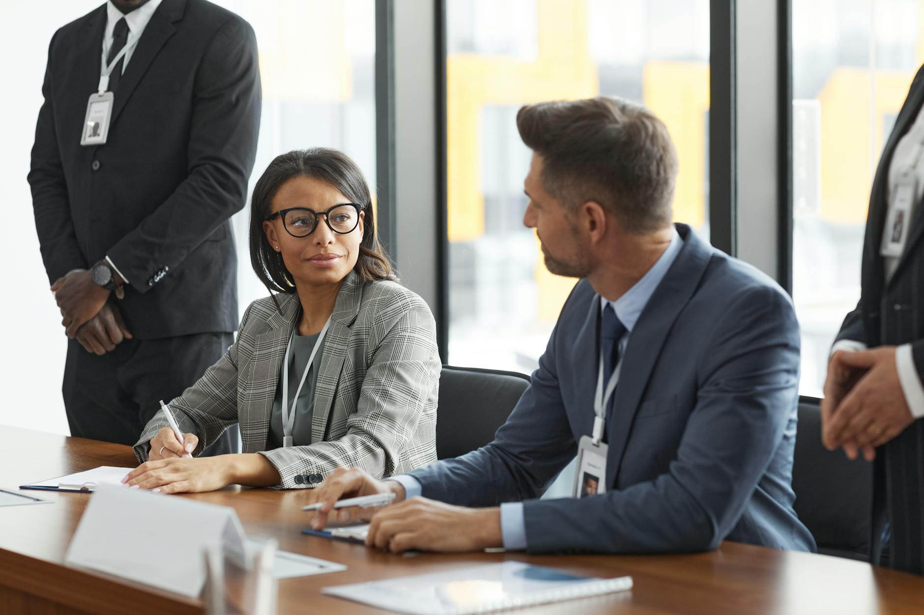 Professional business meeting with executives around conference table discussing strategy