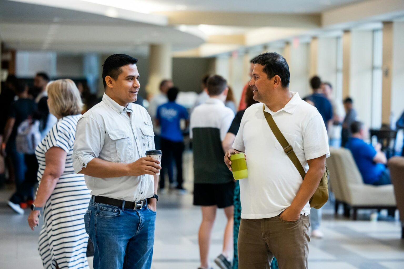 Professional networking event with people in business attire having conversations