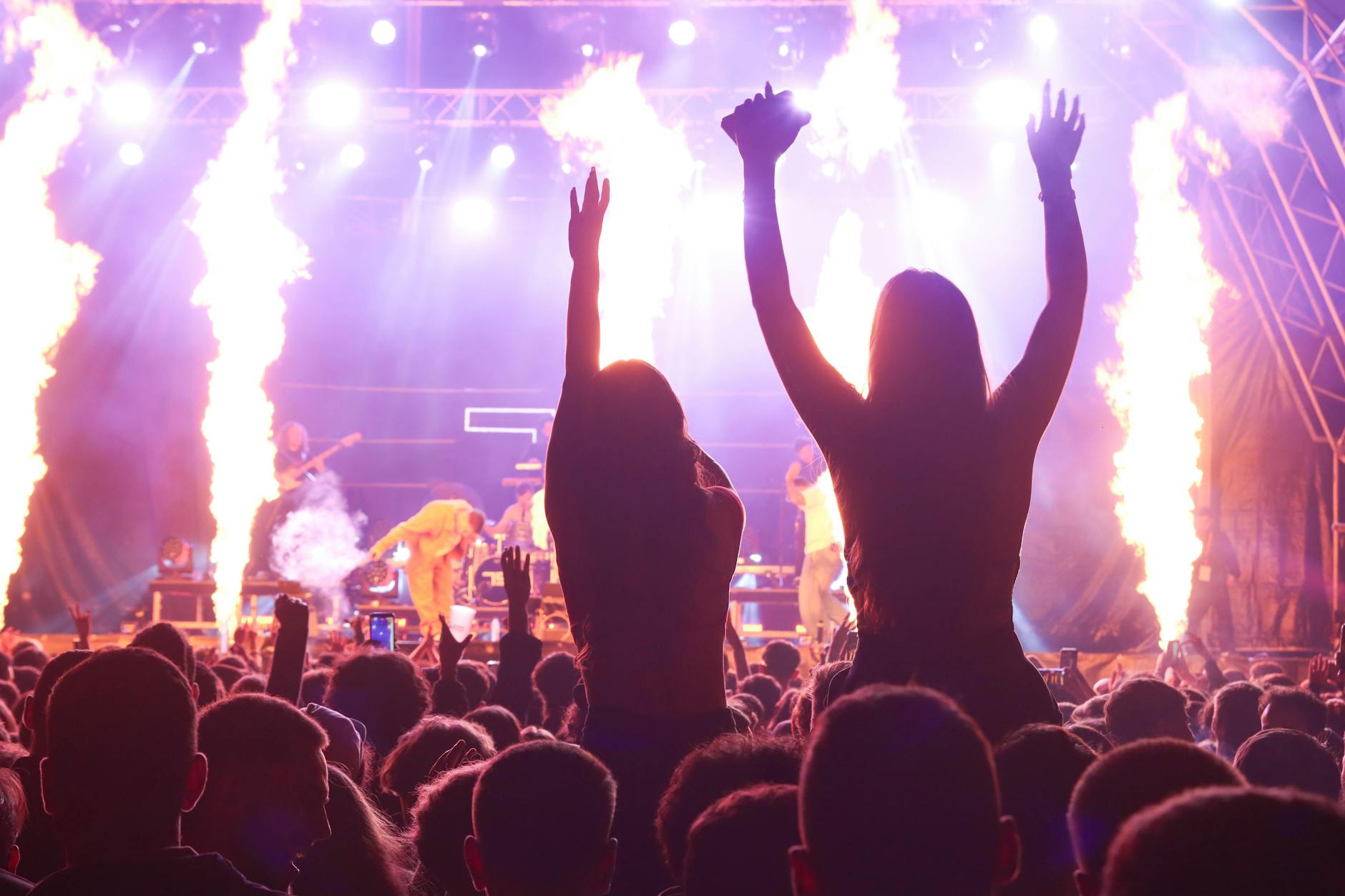 Outdoor music festival scene with crowds and bohemian fashion styles