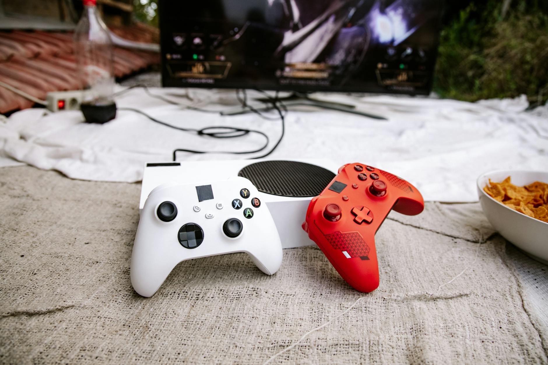 Modern gaming setup with controller and screen showing video game interface