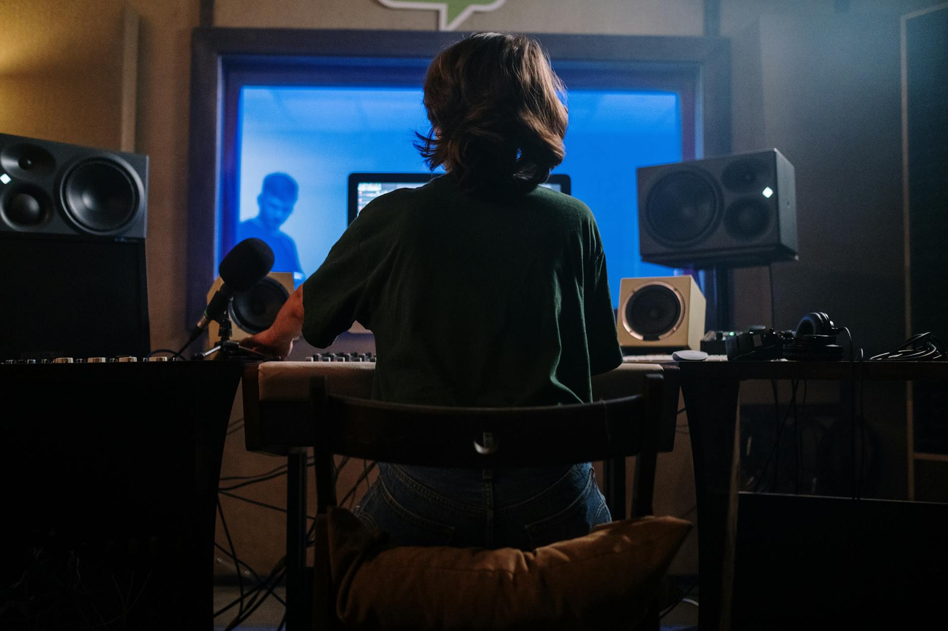 Music producer working at computer with digital audio workstation
