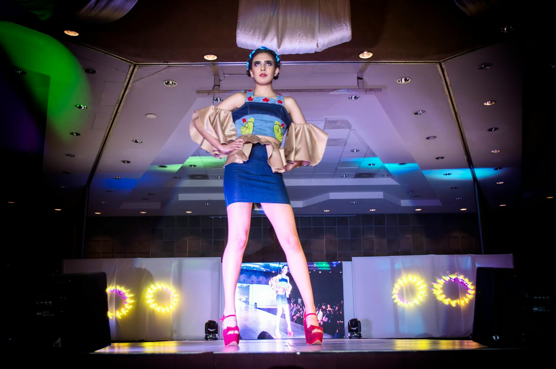 Fashion runway with models showcasing contemporary street style and footwear trends