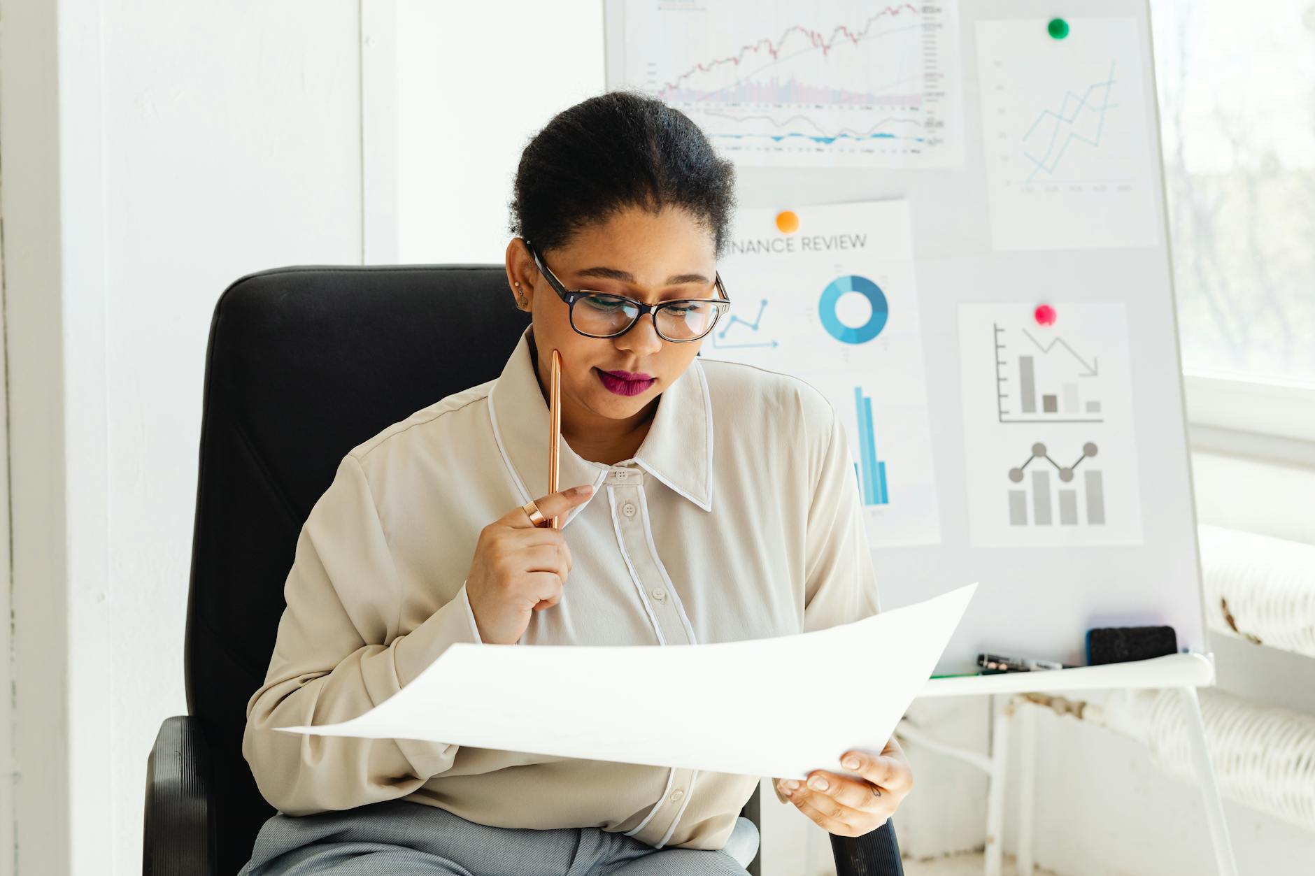 Professional consultant reviewing documents and inventory lists at elegant desk