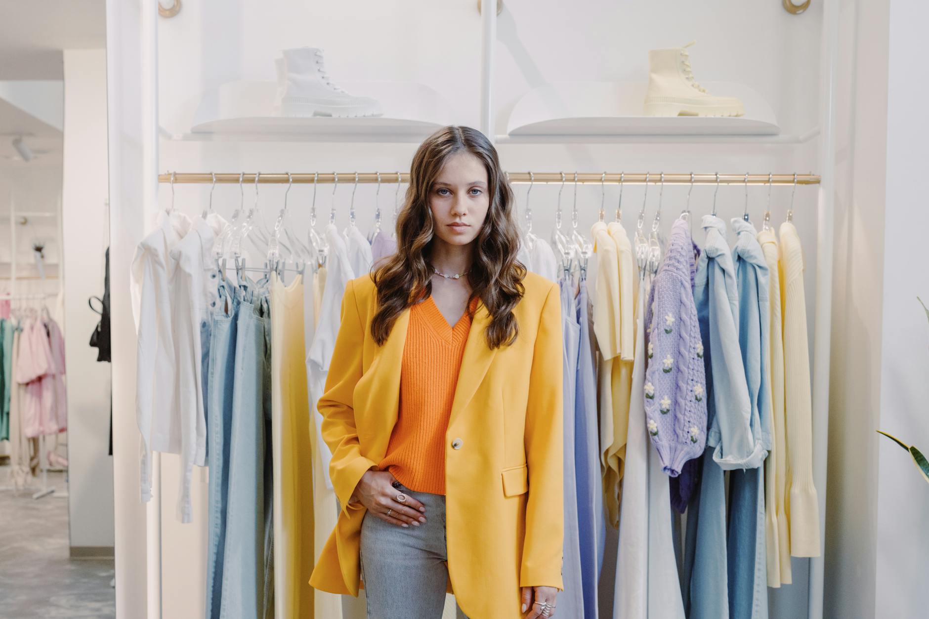 Minimalist fashion showroom interior with clothing displays and professional lighting