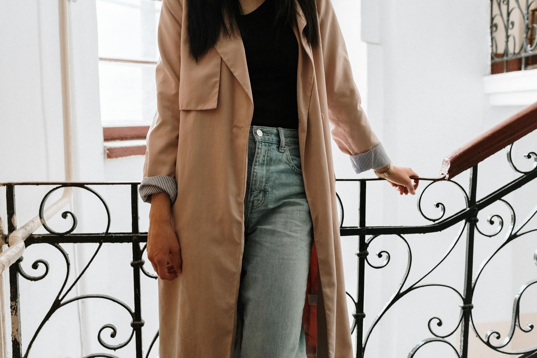 Woman in casual street style outfit walking outdoors in natural lighting