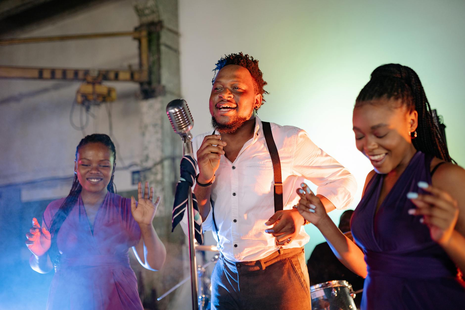 Solo musician performing on stage with dramatic lighting and audio equipment