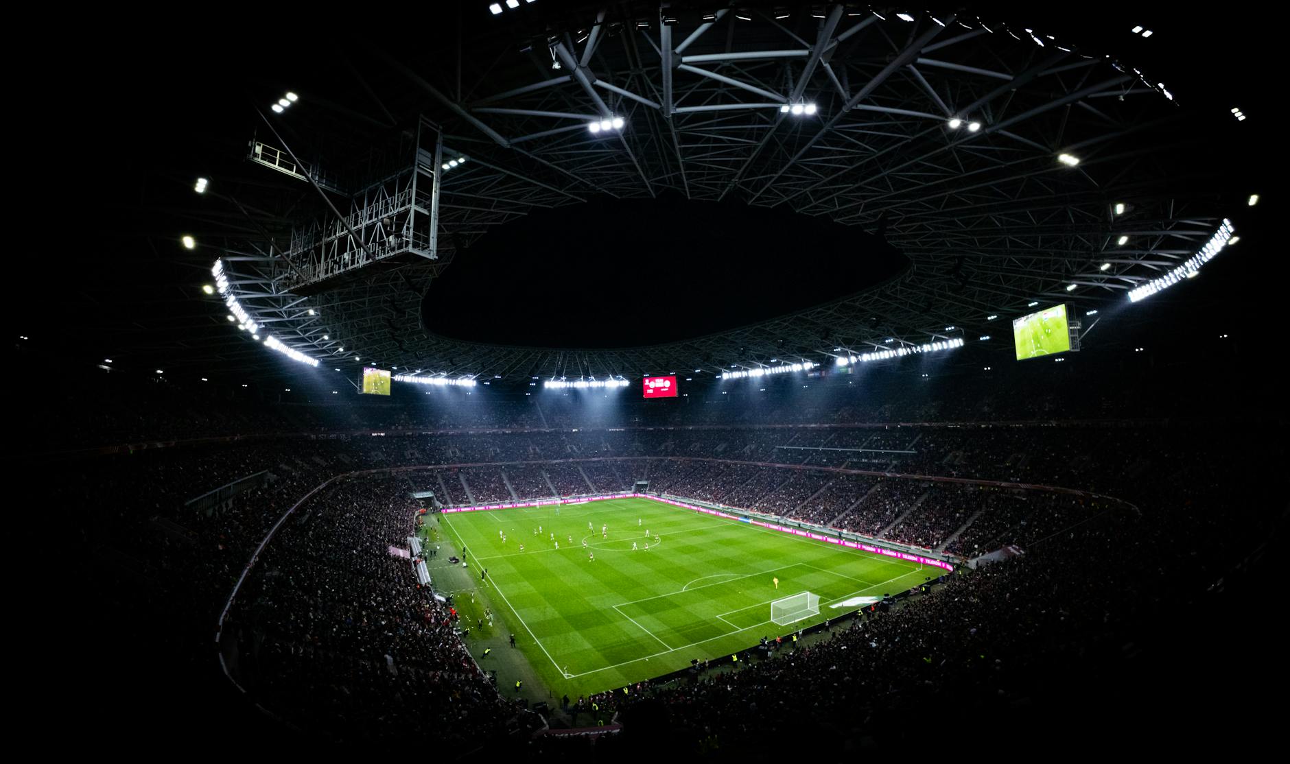Empty football stadium with green field showing professional sports venue