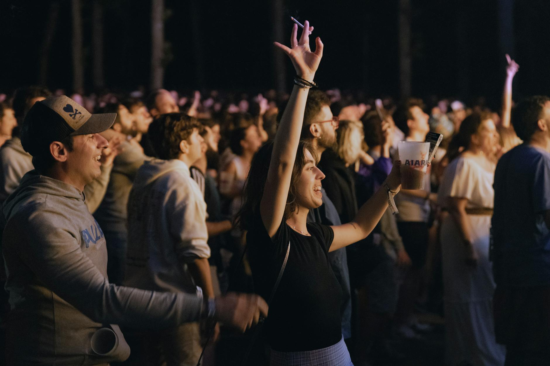 Audience members at film festival screening applauding in darkened theater