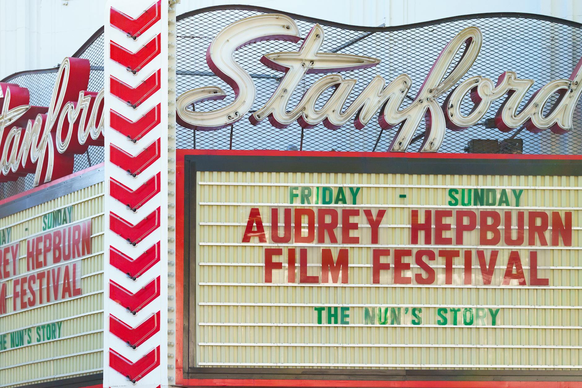 Illuminated Broadway theater marquee sign at night