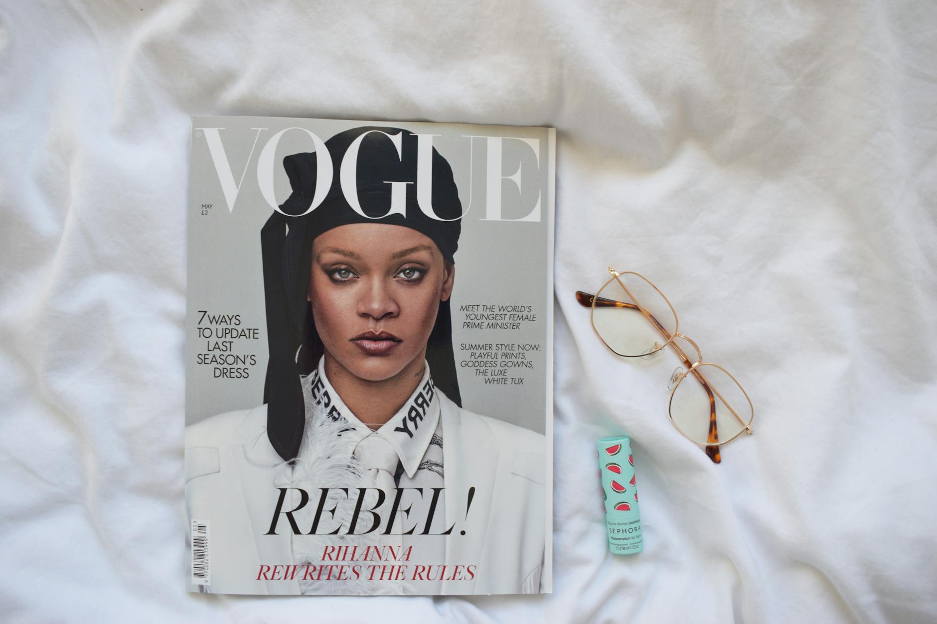 Fashion magazines and editorial content spread on a table showing traditional print media