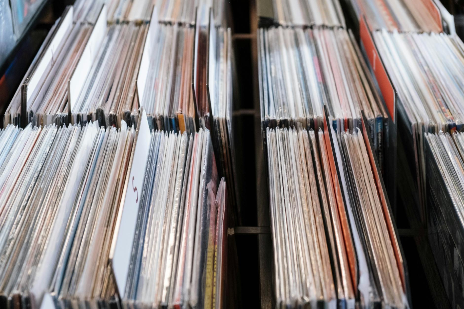 Collection of vinyl records stacked and displayed on surface