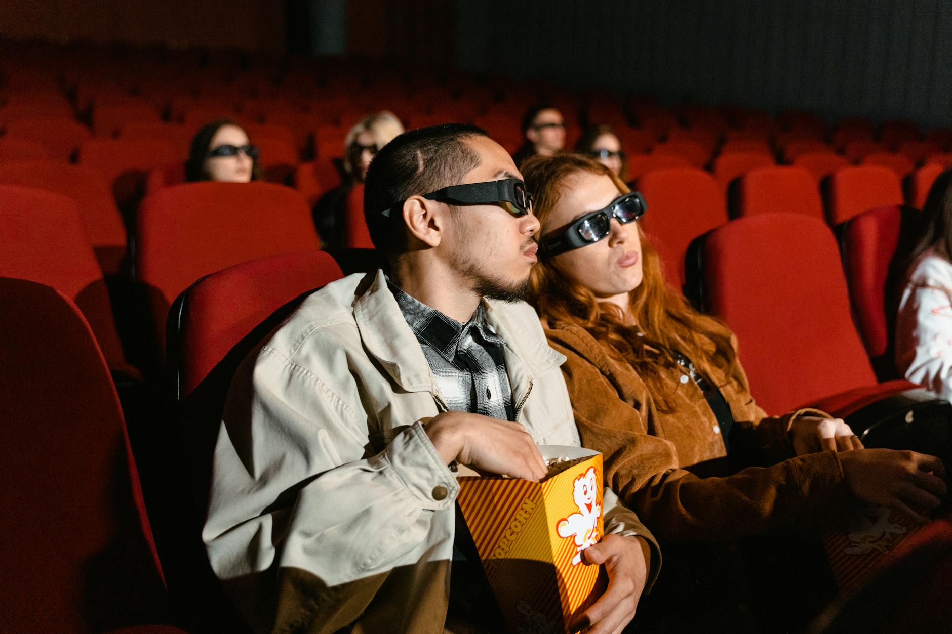 Diverse audience watching a film in a modern movie theater