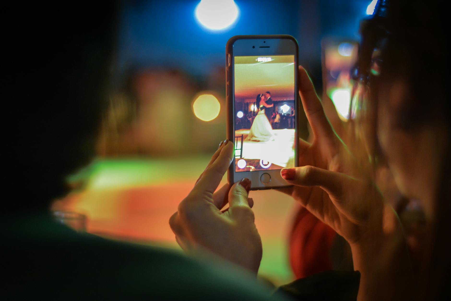 Person holding smartphone while practicing dance moves, representing the intersection of social media and performance