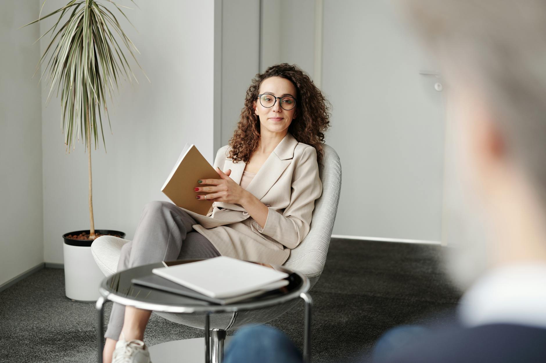 Professional coaching session with two people in modern office setting during consultation