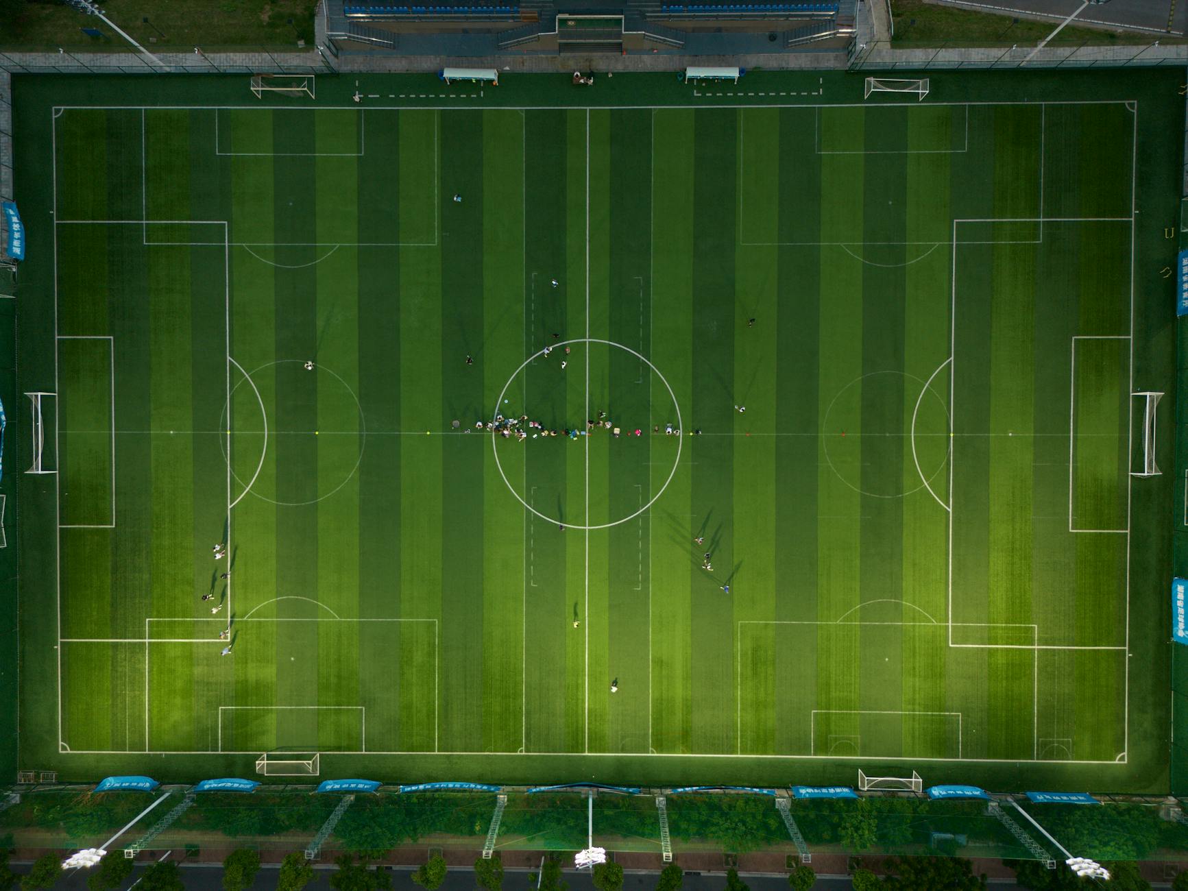 Businessman in suit at sports venue representing professional sports ownership
