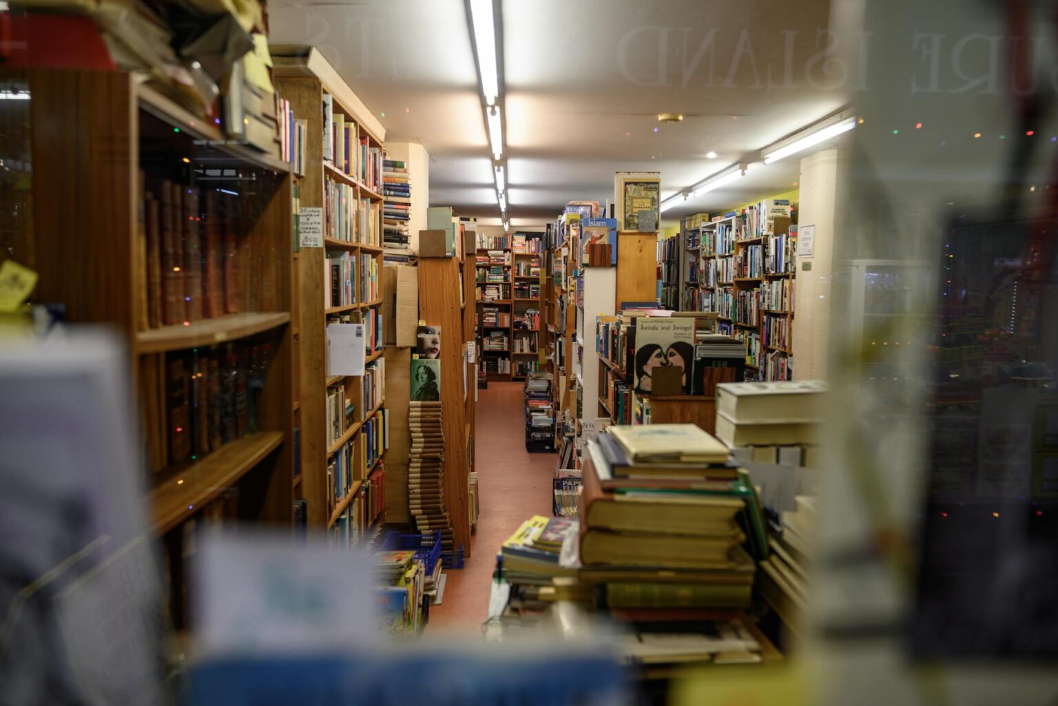 Indie Bookstores Are Quietly Becoming Live Music Venues Cozy independent bookstore interior with wooden shelves and warm lighting