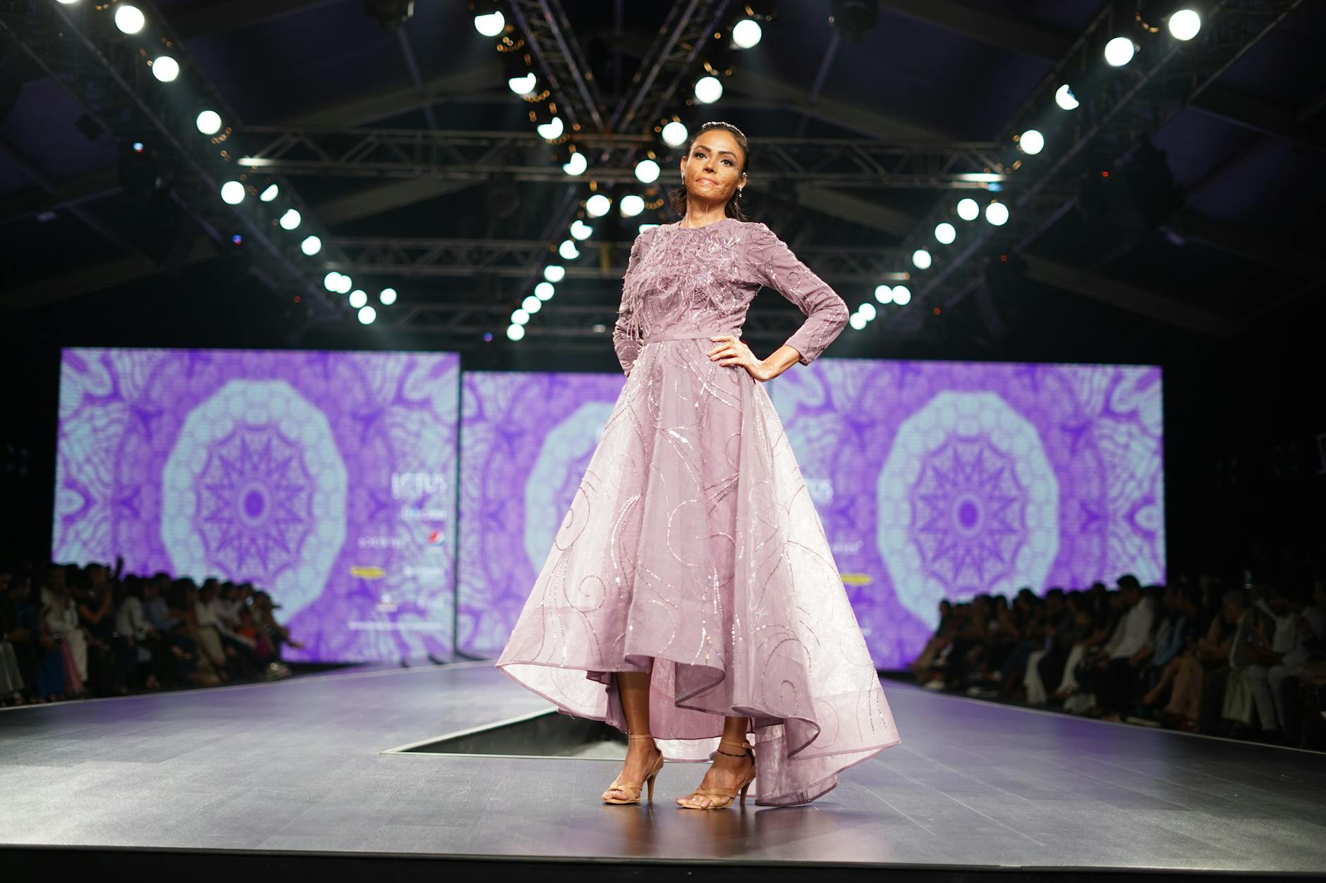 Models walking a high-fashion runway show in avant-garde clothing