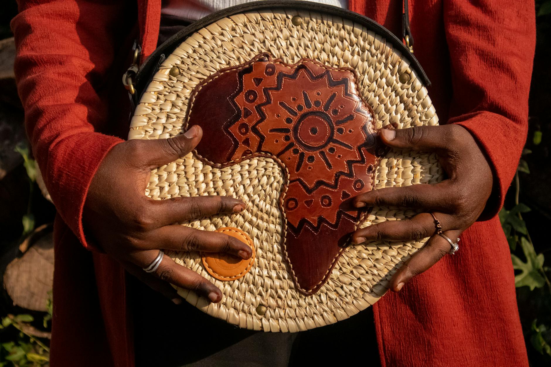 Close-up of a woven leather luxury handbag showing intricate interlaced pattern