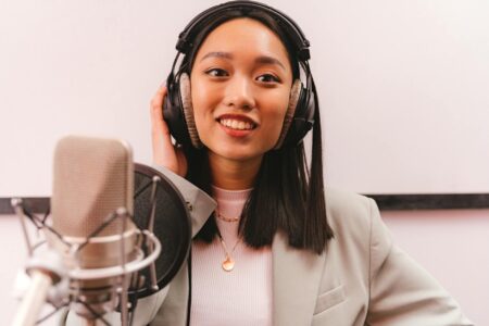 Podcast Festivals Are Quietly Replacing Music Festivals for Gen Z Audience watching a live podcast recording session at an indoor event venue
