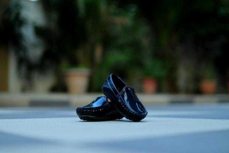 Loro Piana’s Cashmere Loafers Are Replacing Designer Sneakers Close-up of elegant slip-on loafers in soft neutral fabric on a polished floor