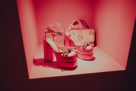 High-end shoes displayed on a minimalist retail shelf, representing luxury footwear presentation