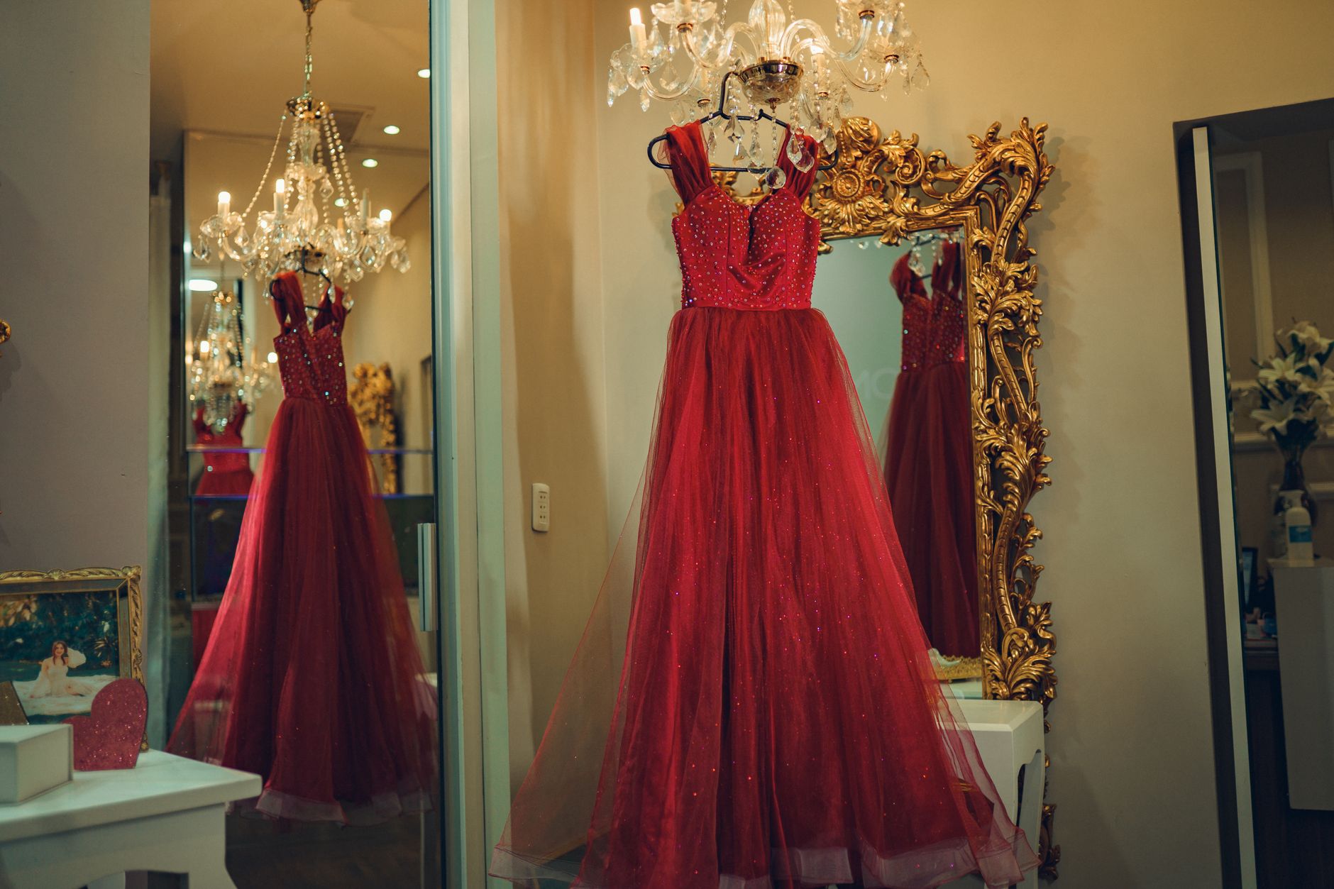 A model wearing a bold red monochromatic gown on a fashion runway
