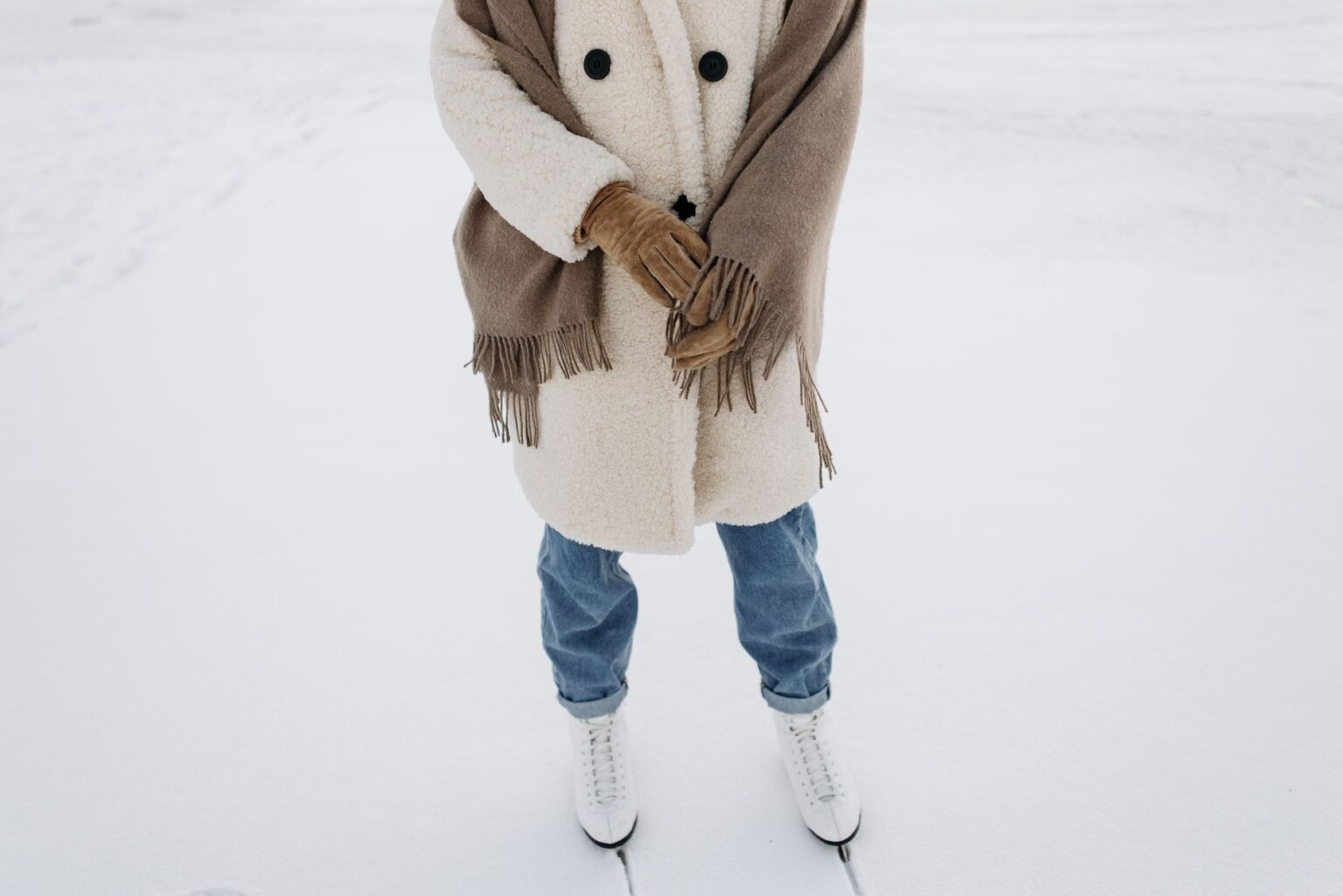 A person wearing an oversized wool wrap coat on a city street in winter
