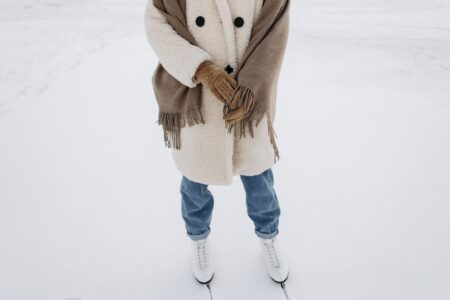 A person wearing an oversized wool wrap coat on a city street in winter