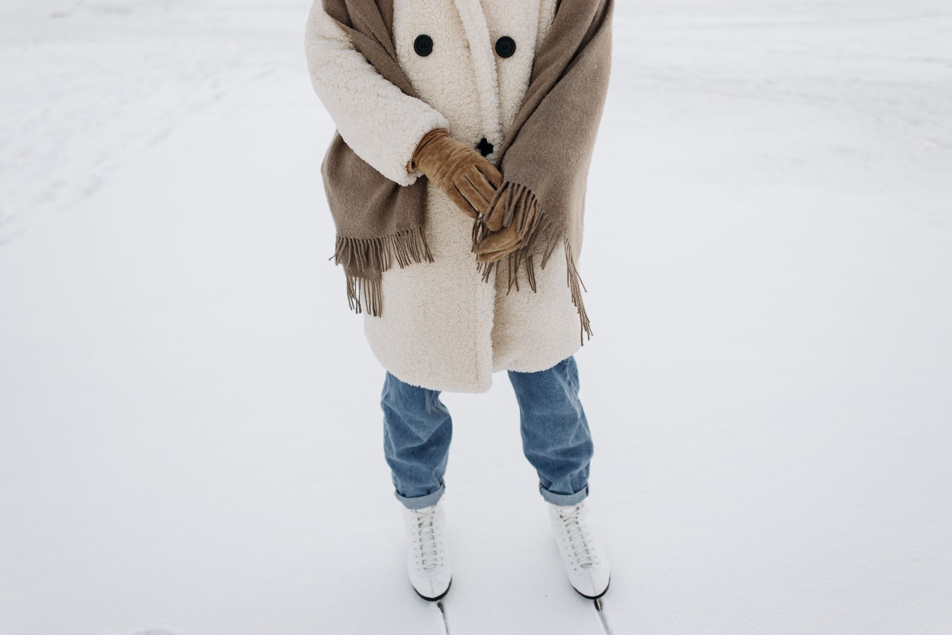 A person wearing an oversized wool wrap coat on a city street in winter