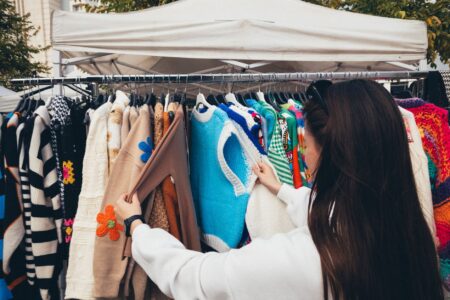 Vintage clothing hanging on racks at a fashion market