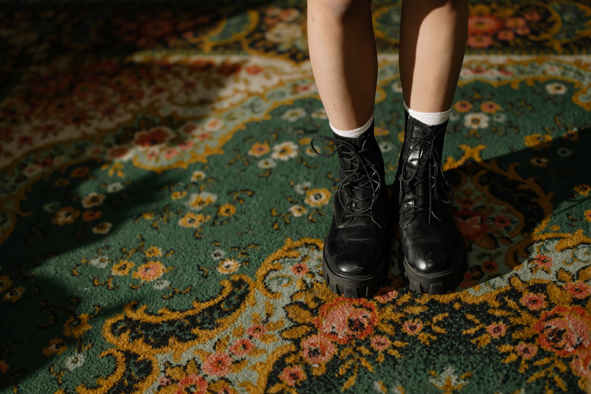 A pair of structured ankle boots with an unusual toe shape displayed on a clean surface