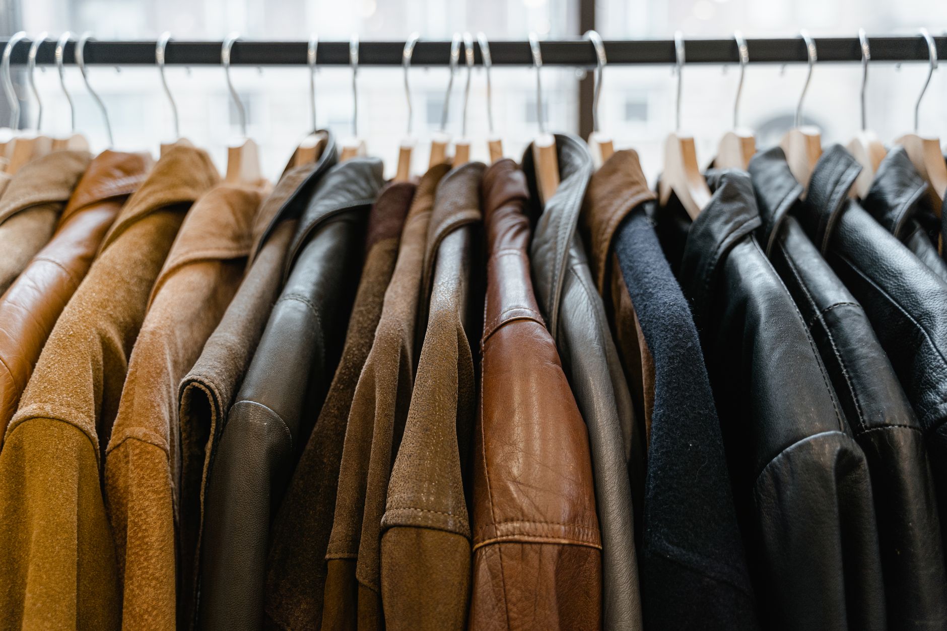 A neatly folded premium wind-resistant jacket in neutral tones on a clean surface