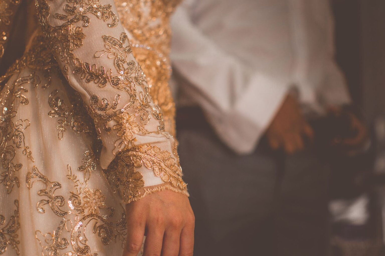 Close-up detail of an elaborate couture gown showing intricate fabric construction and bias-cut technique