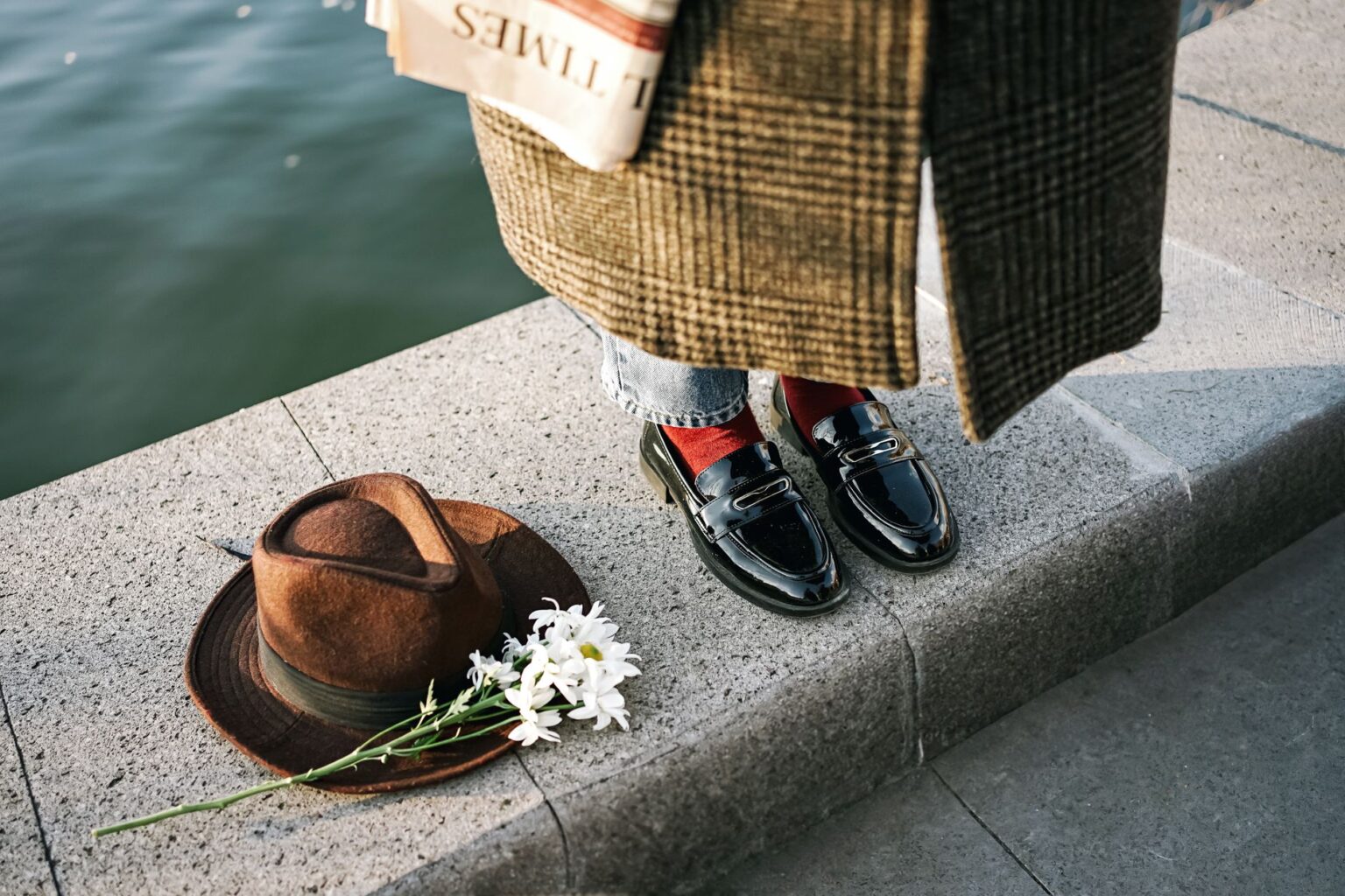 Close-up of polished leather loafers on a city street pavement