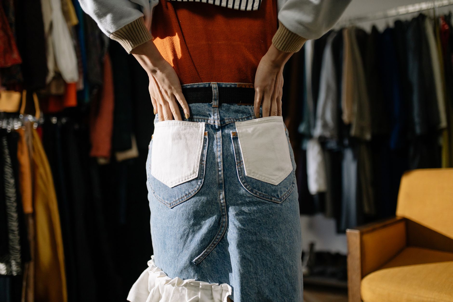 Rows of vintage designer garments hanging in an archive storage space